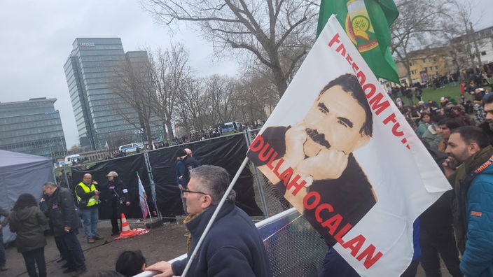 Eine Fahne auf der Abdullah Öcalan abgebildetet ist auf deiner PKK Demo in Köln
