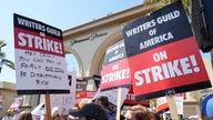 Streikende Mitglieder der Writers Guild halten Schilder während einer Kundgebung vor dem Paramount Pictures Studio