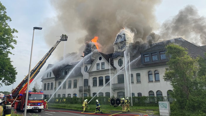 Der Dachstuhl des historischen Gebäudes steht in Flammen