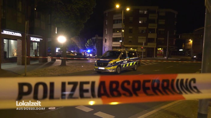 Mit einem rot-weißen Absperrflatterband sichert die Polizei in Mönchengladbach einen Tatort am Fernbusbahnhof