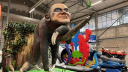 Ein Karnevalswagen stellt Olaf Scholz in Form eines Faultiers dar