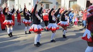 Verkleidete Frauen tanzen in Schleiden-Gemünd auf der Straße