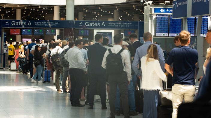 Archivbild: Eine Warteschlange mit Reisenden am Düsseldorfer Flughafen.
