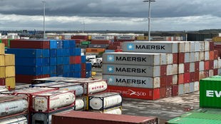 Man sieht einen Hafen mit zahlreichen Industrie-Containern.