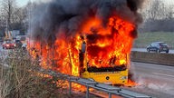 Ein Schulbus der komplett in Flammen steht