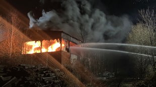 Feuerwehrleute löschen den Brand in einer alten Industriehalle in Gevelsberg (Ennepe-Ruhr-Kreis)