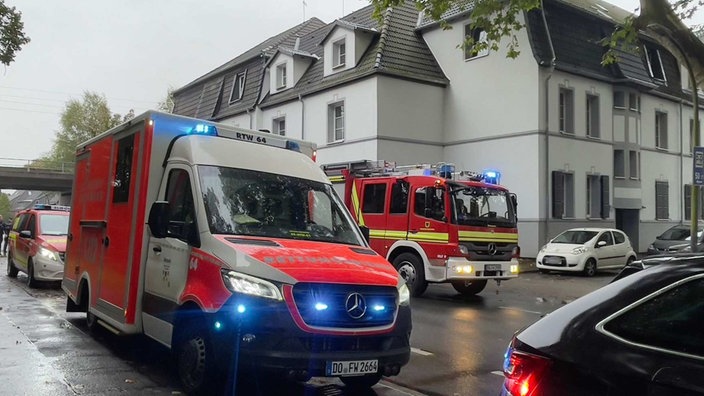 Mehrere Feuerwehrautos vor einem Mehrfamilienhaus