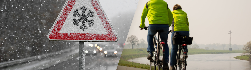 Verkehrszeichen Schnee- oder Eisglätte und zwei Radfahrer auf dem Weser-Radweg.