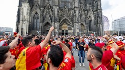 Fans von Spanien und Georgien feiern zusammen vor dem Kölner Dom auf der Domplatte