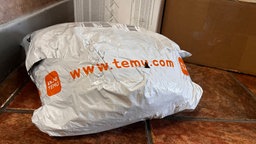 Ein Paket von Temu liegt vor einer Tür