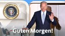 US-Präsident Joe Biden winkt beim Verlassen der Air Force One am Flughafen in München, davor ein "Guten Morgen!" Schriftzug