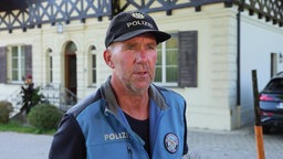 Foto von Jörg Fett mit einer Cap und Polizeiweste