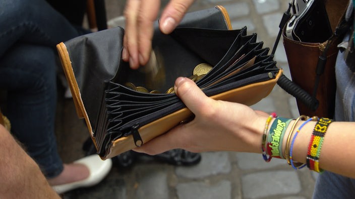 Kellnerin wirft Münzen in ihre Geldbörse
