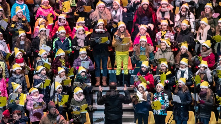 16.12.2018, Nordrhein-Westfalen, Dortmund: Der WDR Kinderchor der Chorakademie Dortmund singt beim nach Veranstalterangaben größten Weihnachtssingen Deutschlands im Signal Iduna Park