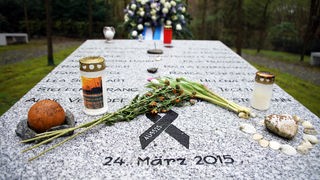 Gedenkstein der Absturz-Opfer von Haltern mit Blumen und Steinen geschmückt