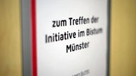 Schild mit der Aufschrift: "zum Treffen der Initiative im Bistum Münster"