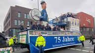 Der Wagen der "Spielmannszug Bürgerschützen Hauenhorst" mit Karnevalisten auf dem Rosenmontagsumzug in Rheine.