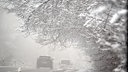 Autos fahren an schneebedeckten Bäumen in der Eifel vorbei