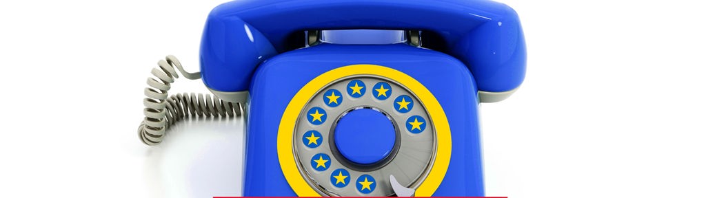 Satirische Fotomontage: Ein altes Wählscheiben-Telefon in den Farben der EU mit gelben Sternen statt Ziffern