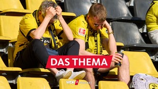 Enttäuschte BVB-Fans sitzen nach dem Spiel gegen den FSV Mainz 05 im Stadion