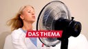 Frau in den Wechseljahren kämpft gegen die Hitzewallungen und sucht Abkühlung durch einen Ventilator