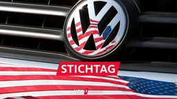 Die US-Fahne spiegelt sich in Logo und Kühlergrill eines Volkswagen-Fahrzeugs