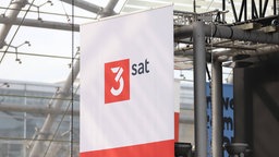 Banner mit dem Logo von 3sat bei der Leipziger Buchmesse am 22.03.2024.