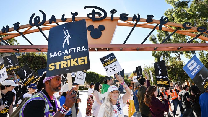 Vor den Walt Disney halten Streikende Plakate in die Luft.