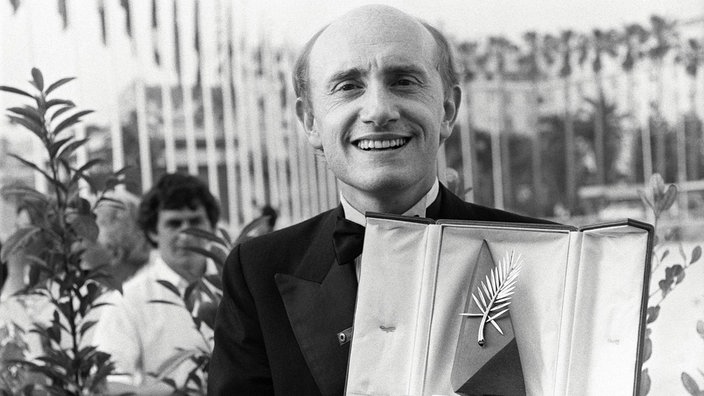 Der Schauspieler, Regisseur und Drehbuchautor Michel Blanc posiert mit dem Preis für den besten Schauspieler, 19. Mai 1986.