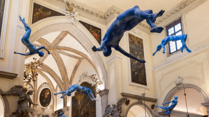 Eine Roger Federer nachgebildete Figur ist wie eine blaue Wolke bemalt und schwebt als Teil der Installation "Burn Shine Fly" in einem Kirchenraum.