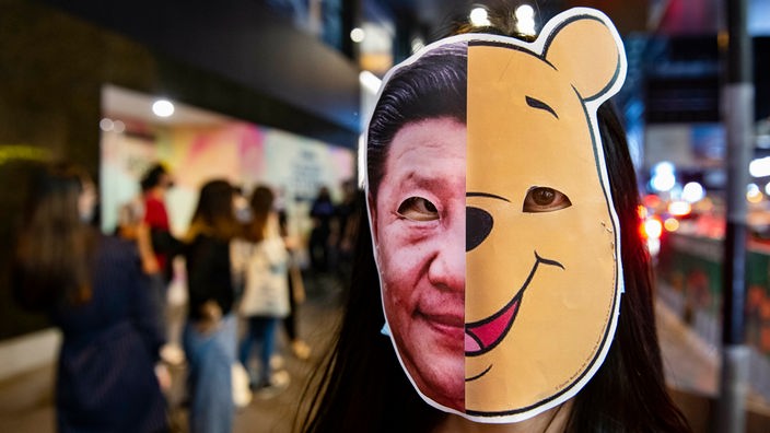  Eine Demonstrantin trägt eine Winnie Pooh und Xi Jinping Maske während der Proteste.