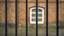Blick aus einem vergittertem Fenster im Gefängnis.