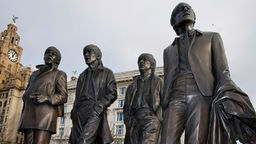 Lebensgroße Statuen der Beatles vor dem Liverbuilding in Liverpool.
