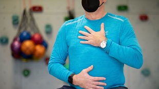 Ein Long-Covid-Patient macht ein Atemtraining in einem Gymnastikraum einer Reha-Klinik für Post-Covid Erkrankte