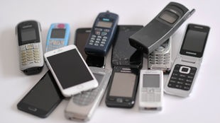 Viele alte und neue Handys liegen zusammen auf einem Haufen