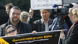 Protestteilnehmern mit Plakaten gegen die Streichung von Fördermittel für Gemeinsam gegen Kälte e.V. vor dem nordrhein-westfälischen Landtag in Düsseldorf