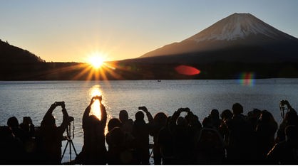 Touristen fotografieren in Kofu (Japan) am Shoji-See zu Füßen des Fuji den Sonnenaufgang, 01.01.2018.