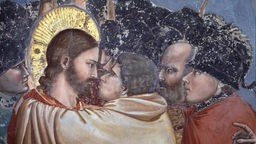 Detail aus einem Fesco von Giotto di Bondone zeigt, wie Judas Jesus küsst
