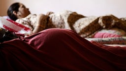 Zwei werdende Mütter liegen auf den Betten einer Klinik für Leihmutterschaften in Anand, Indien.