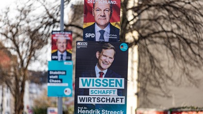 An Straßenlaternen in Bonn hängen Wahlplakate der CDU und der SPD. Aufschrift SPD (Scholz): "Mehr für Dich. Besser für Deutschland." Aufschrift CDU (Streeck): "Wissen schafft Wirtschaft"