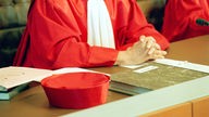 Symbolbild: Richter:in des Bundesverfassungsgerichts in roter Robe (Ausschnitt)
