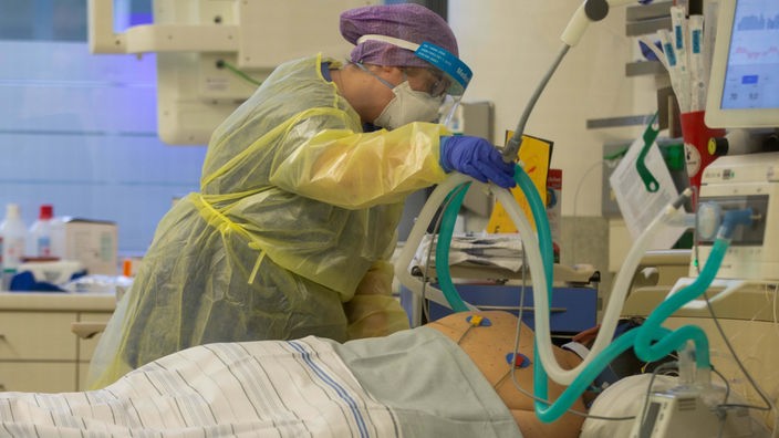 Symbolbild: Eine Krankenpfleger:in betreut auf der Intensivstation des Krankenhauses Düren einen an Covid erkrankten Menschen, der künstlich beatmet wird (25.12.2021).