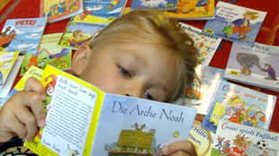 Ein Kind liest in einem Pixi-Buch.