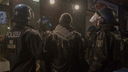 Pro-palästinensischer Demonstrant zwischen zwei Polizeikräften in Berlin (07.10.2023)