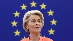 Ursula von der Leyen, im Hintergrund der EU-Sternenkranz auf blauem Grund.
