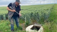 Kartoffelbauer Heinz-Georg Olligs sthet auf dem Acker an einem Brunnenloch seines "Bewässerungsverband Pütz" in Bedburg