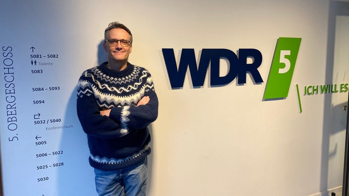 Ralf Kabelka vor dem WDR 5 Logo