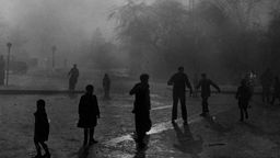 Smoke in London am 8. Dezember 1952. Menschen gehen im dunklen Dunst über die Straße.