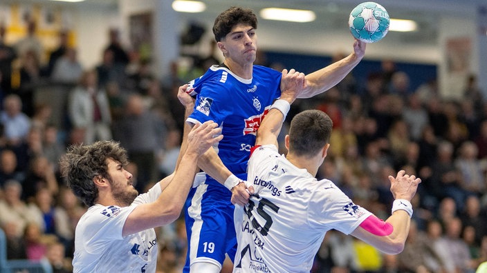 Giorgi Tskhovrebadze vom VfL Gummersbach gegen zwei Spieler des HSV Hamburg