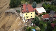 Erdrutsch, zerstörtes Wohnhaus